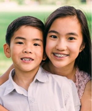 Preteen sister and brother with pediatric orthodontics
