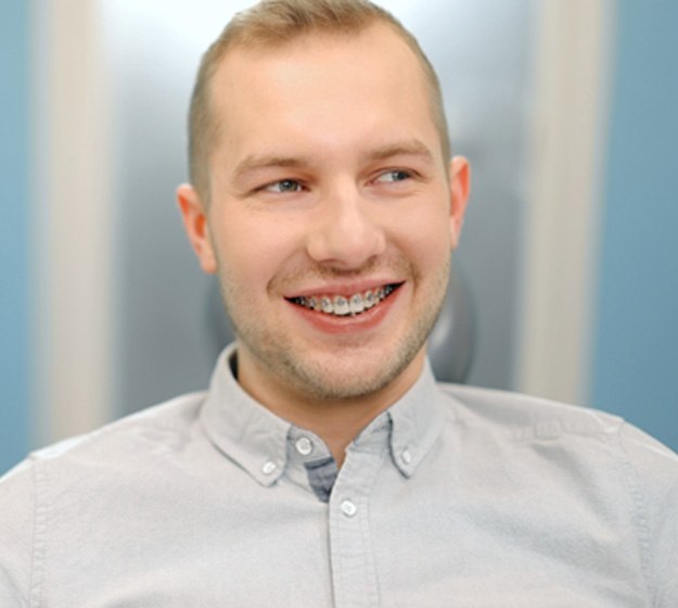 Smiling male dental patient with braces