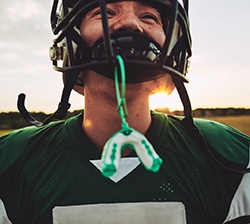Mouthguard hanging from helmet