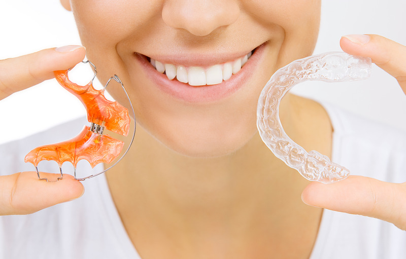 Patient smiling with their retainer